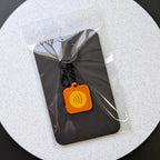 Packaging for keychain on a white circular background. 
