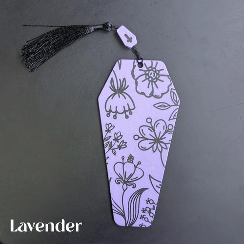 Lavender coffin bookmark with floral patterns on a dark gray background