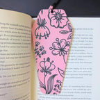 Pink floral bookmark on an open book
