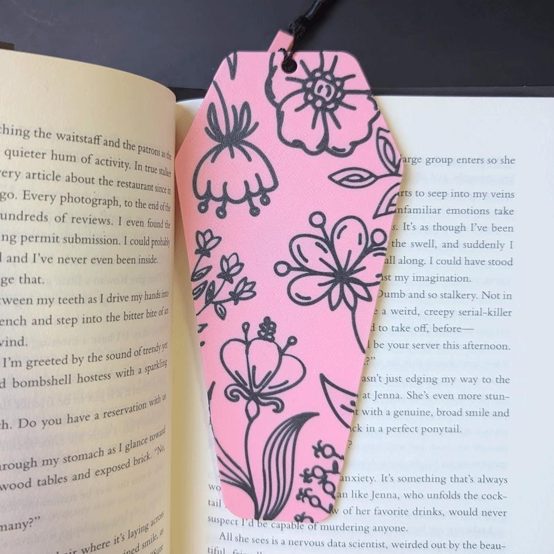 Pink floral bookmark on an open book