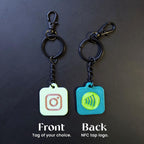 Two keychains with different logos on a dark background